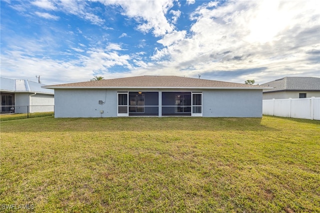 back of property featuring a yard