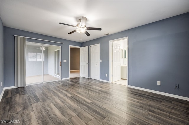 unfurnished bedroom with ceiling fan, wood-type flooring, and ensuite bathroom