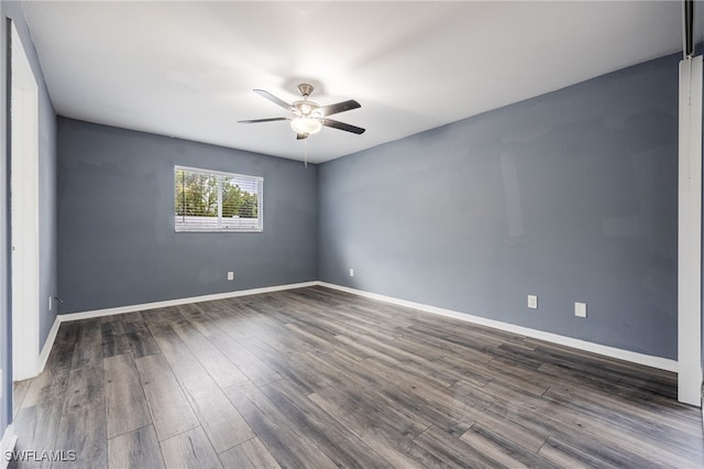empty room with dark wood-type flooring and ceiling fan