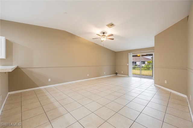 unfurnished room with light tile patterned floors, vaulted ceiling, and ceiling fan