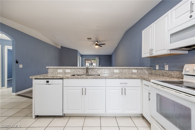 kitchen with white appliances, white cabinets, sink, kitchen peninsula, and light tile patterned flooring