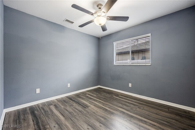spare room with ceiling fan and dark wood-type flooring
