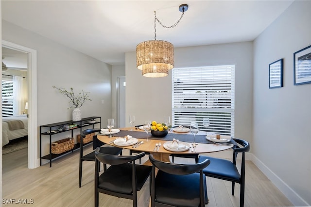 dining space with a notable chandelier and light wood-type flooring