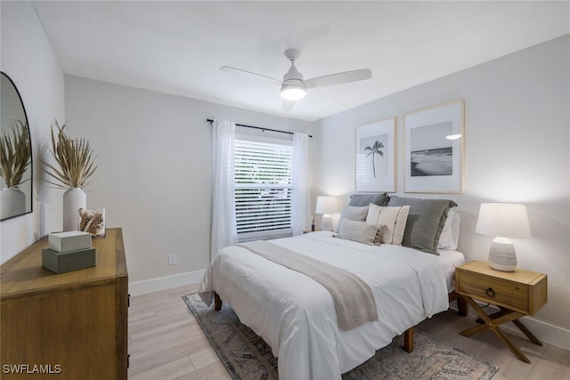 bedroom with ceiling fan and light wood-type flooring