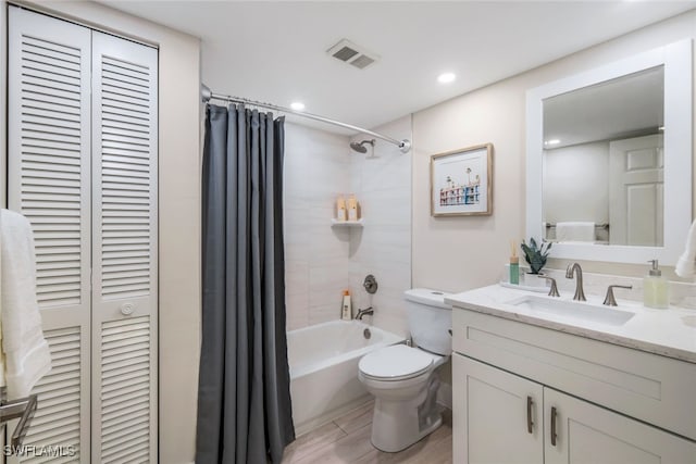 full bathroom featuring toilet, shower / bath combination with curtain, and vanity