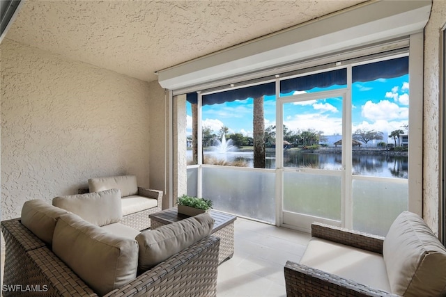 sunroom / solarium featuring a water view