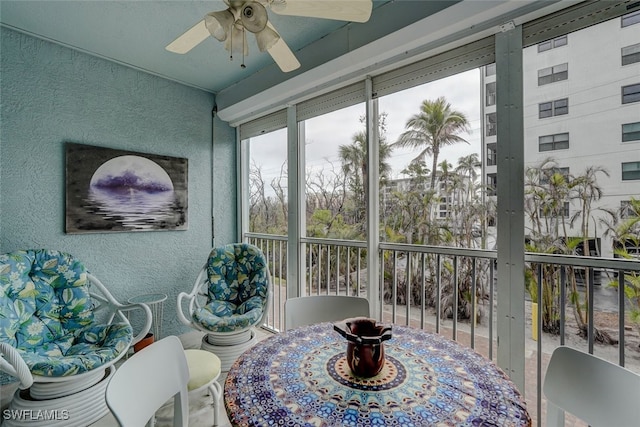 sunroom / solarium featuring ceiling fan