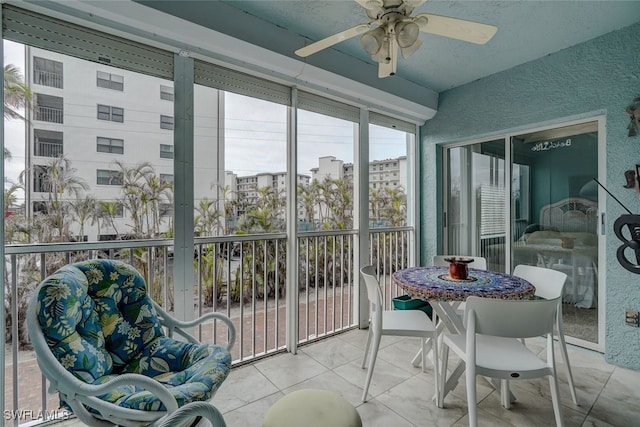 sunroom / solarium featuring ceiling fan