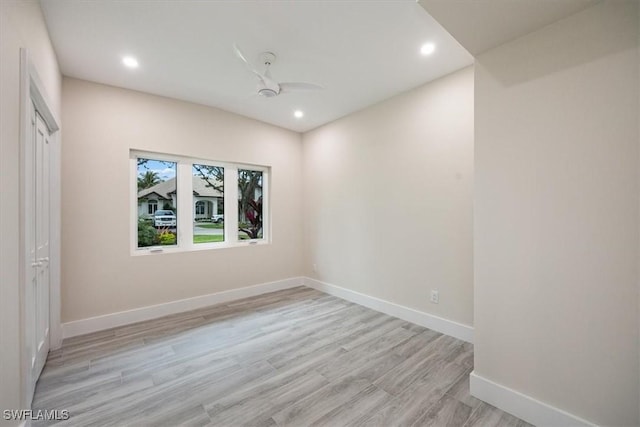 empty room featuring light wood-type flooring, ceiling fan, baseboards, and recessed lighting