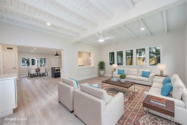 living area with vaulted ceiling with beams, wooden ceiling, recessed lighting, baseboards, and light wood-style floors