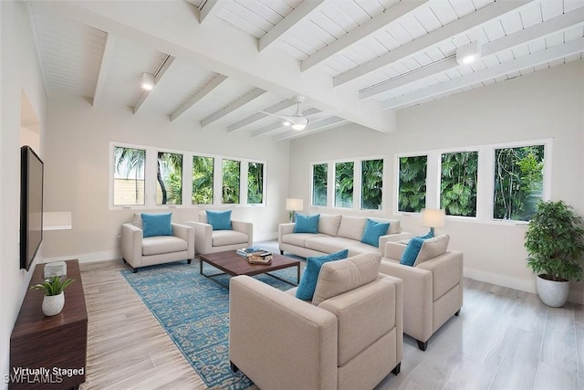 sunroom featuring plenty of natural light and vaulted ceiling with beams