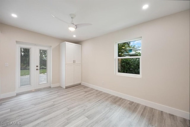 unfurnished room with light wood-type flooring, french doors, baseboards, and recessed lighting