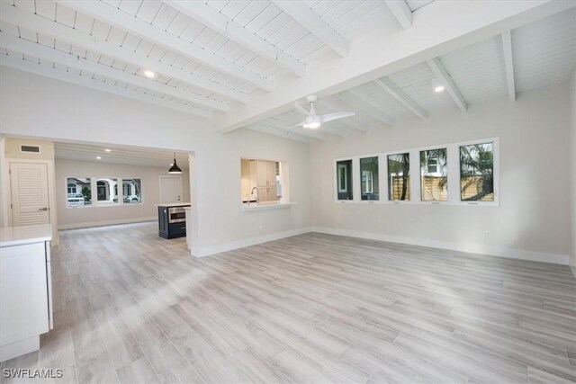 unfurnished living room with light wood-type flooring, wood ceiling, vaulted ceiling with beams, and baseboards