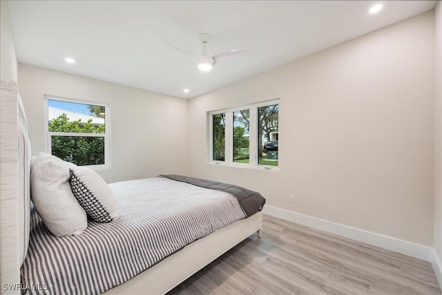 bedroom featuring light wood finished floors, recessed lighting, a ceiling fan, and baseboards