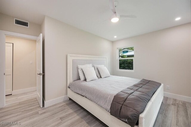 bedroom with light wood finished floors, recessed lighting, visible vents, and baseboards