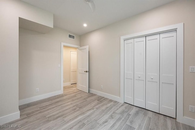 unfurnished bedroom with recessed lighting, a closet, visible vents, light wood-type flooring, and baseboards