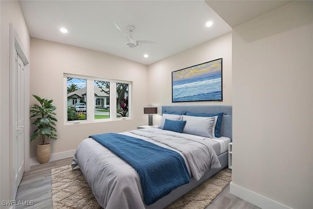 bedroom with light wood-style floors, baseboards, a ceiling fan, and recessed lighting