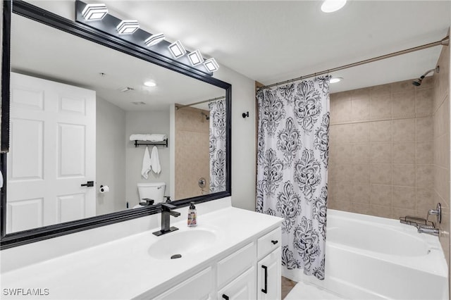 full bathroom featuring toilet, shower / bath combination with curtain, and vanity