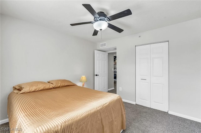 bedroom with ceiling fan, dark carpet, and a closet