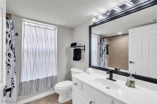 full bathroom featuring toilet, tile patterned flooring, vanity, and shower / bath combo with shower curtain