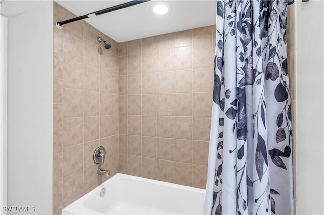 bathroom with shower / bath combination with curtain