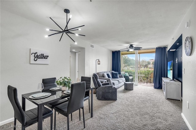 carpeted living room with ceiling fan with notable chandelier