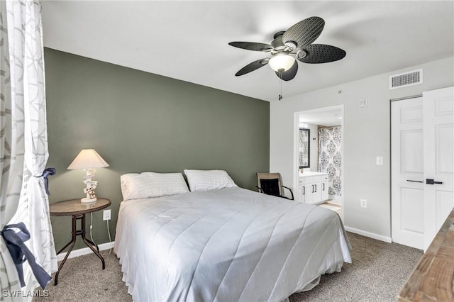 bedroom featuring ensuite bathroom, ceiling fan, and carpet flooring