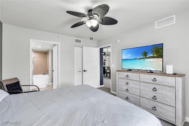 carpeted bedroom with ceiling fan, a closet, and ensuite bath