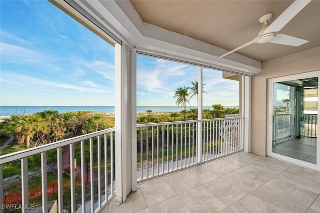 balcony with a water view and ceiling fan