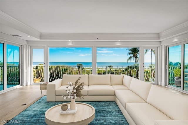 sunroom / solarium with a wealth of natural light and a water view