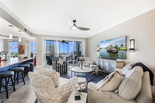 tiled living room with ceiling fan and ornamental molding