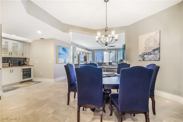 dining area with an inviting chandelier, wet bar, and beverage cooler