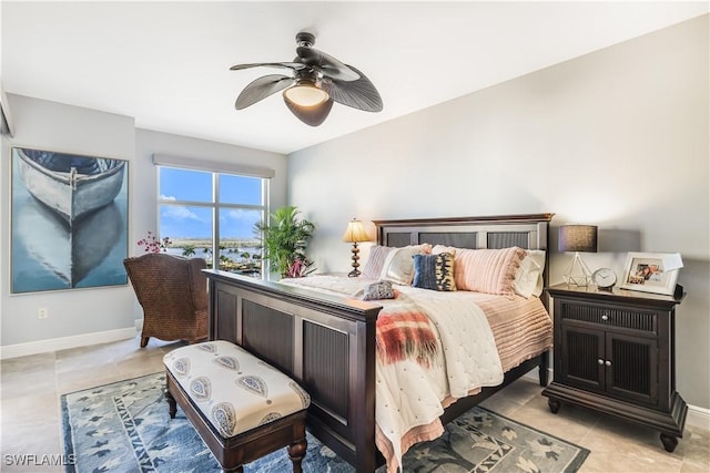 tiled bedroom featuring ceiling fan