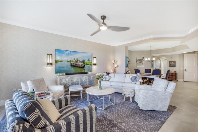 living room featuring ornamental molding and ceiling fan with notable chandelier