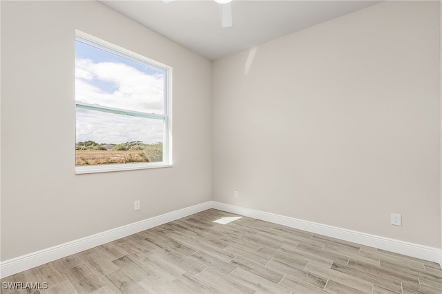 unfurnished room with ceiling fan and light wood-type flooring