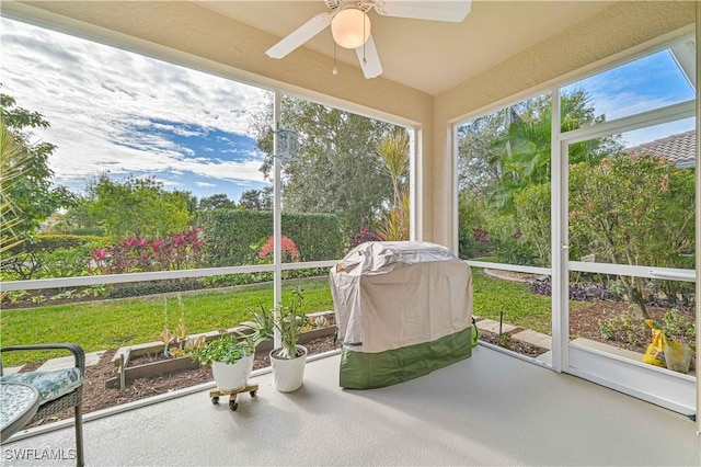 unfurnished sunroom featuring ceiling fan