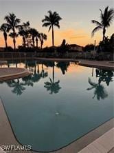 view of pool at dusk