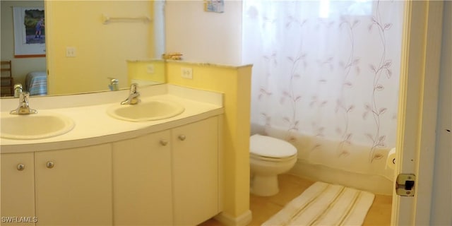 bathroom with toilet, tile patterned flooring, and vanity