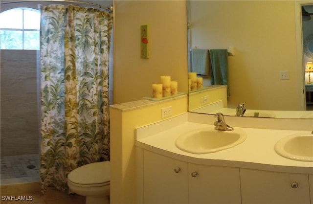 bathroom with toilet, tile patterned floors, vanity, and curtained shower