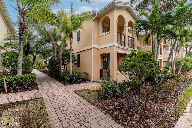 view of front of home with a gate and stucco siding