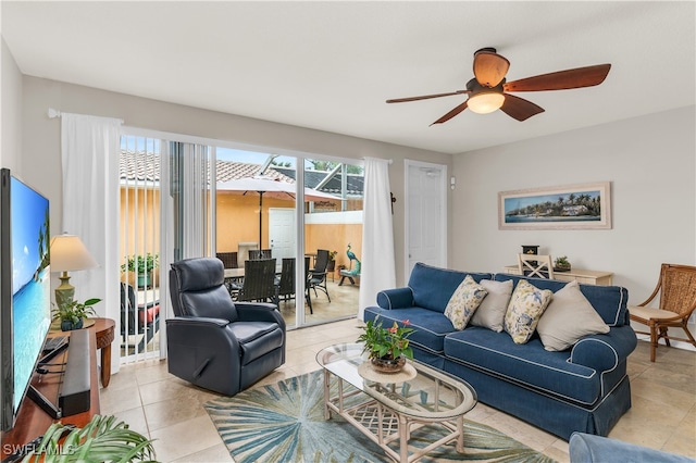 living room featuring ceiling fan, tile patterned flooring, and a healthy amount of sunlight