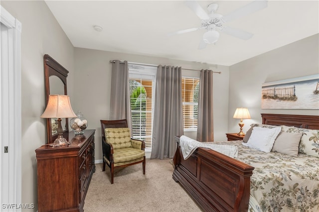 bedroom with ceiling fan and light colored carpet