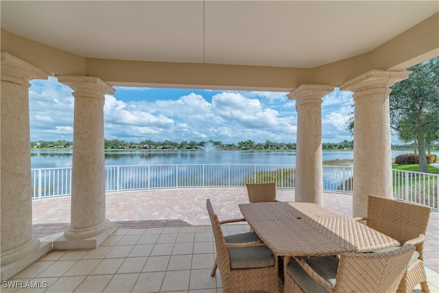 view of patio / terrace with outdoor dining area and a water view