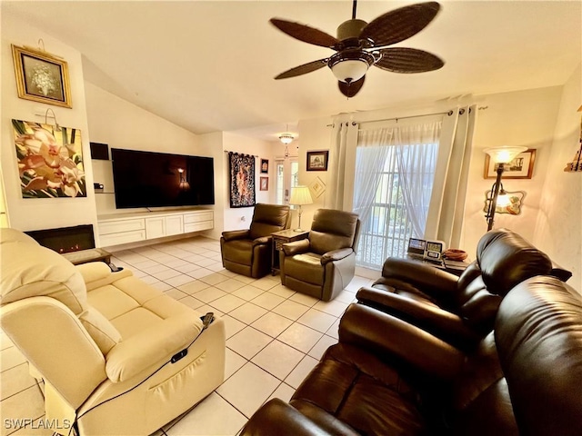 living room with ceiling fan, vaulted ceiling, and light tile patterned flooring