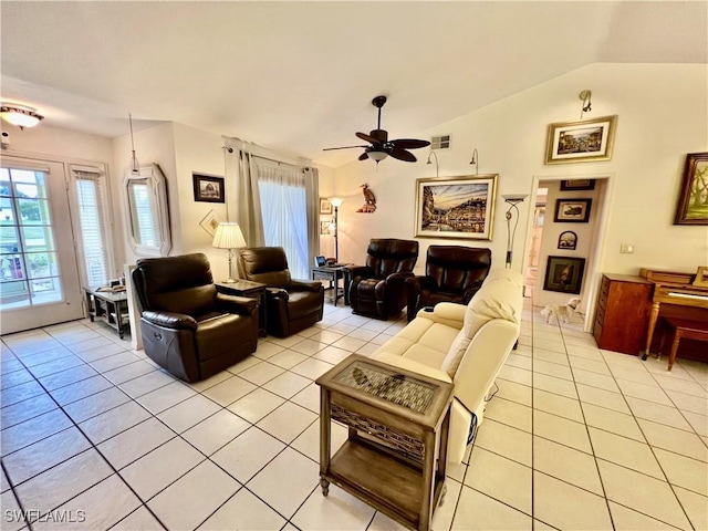 tiled living room featuring a fireplace, vaulted ceiling, and ceiling fan