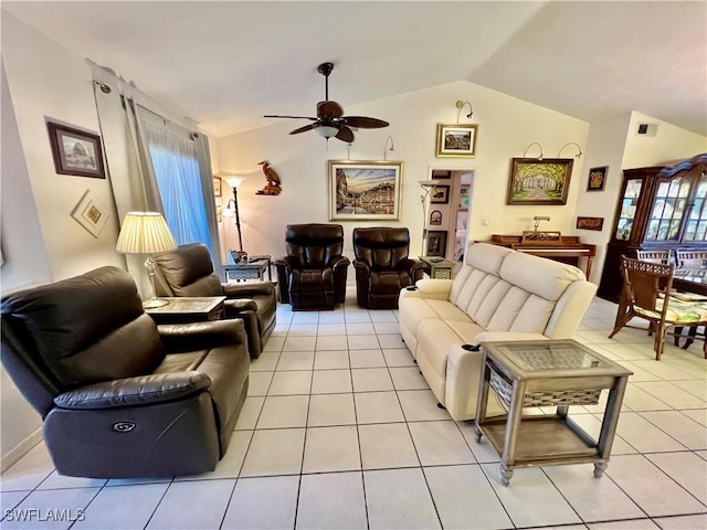 living room featuring ceiling fan, light tile patterned floors, and lofted ceiling