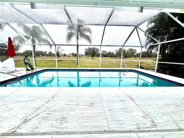 view of pool with glass enclosure