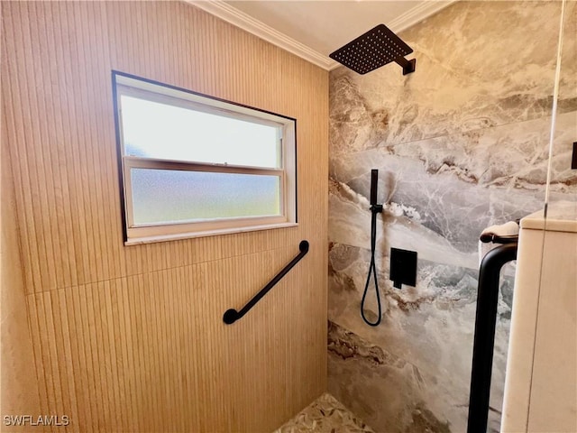 bathroom featuring crown molding and a tile shower