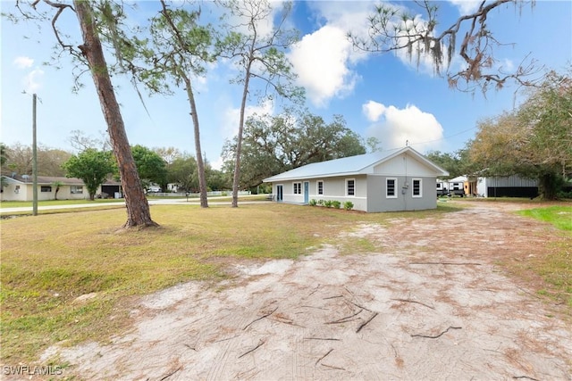 view of side of home with a lawn