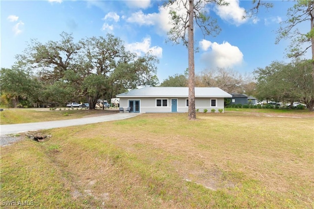 ranch-style home with a front lawn